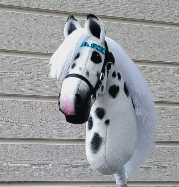 White hobbyhorse with large black dots